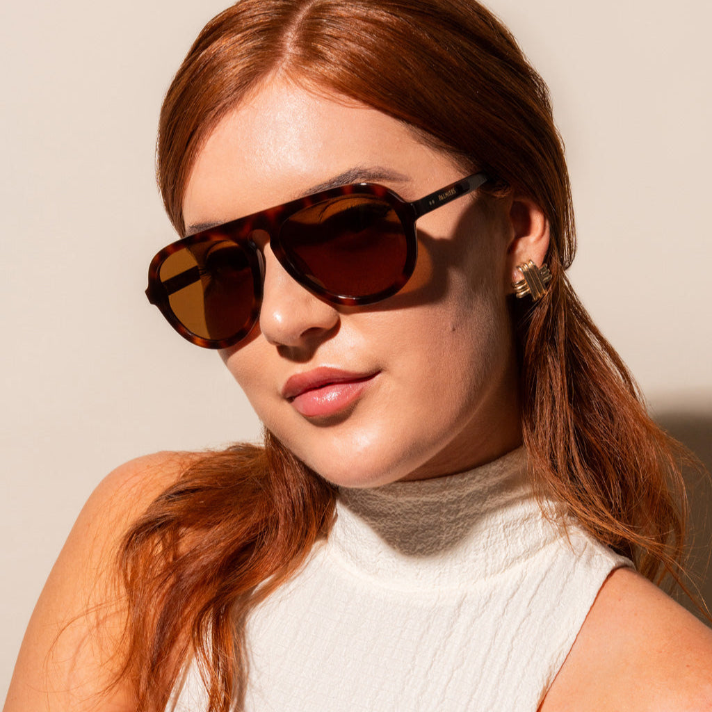 brown sunglasses with tortoise frame on woman