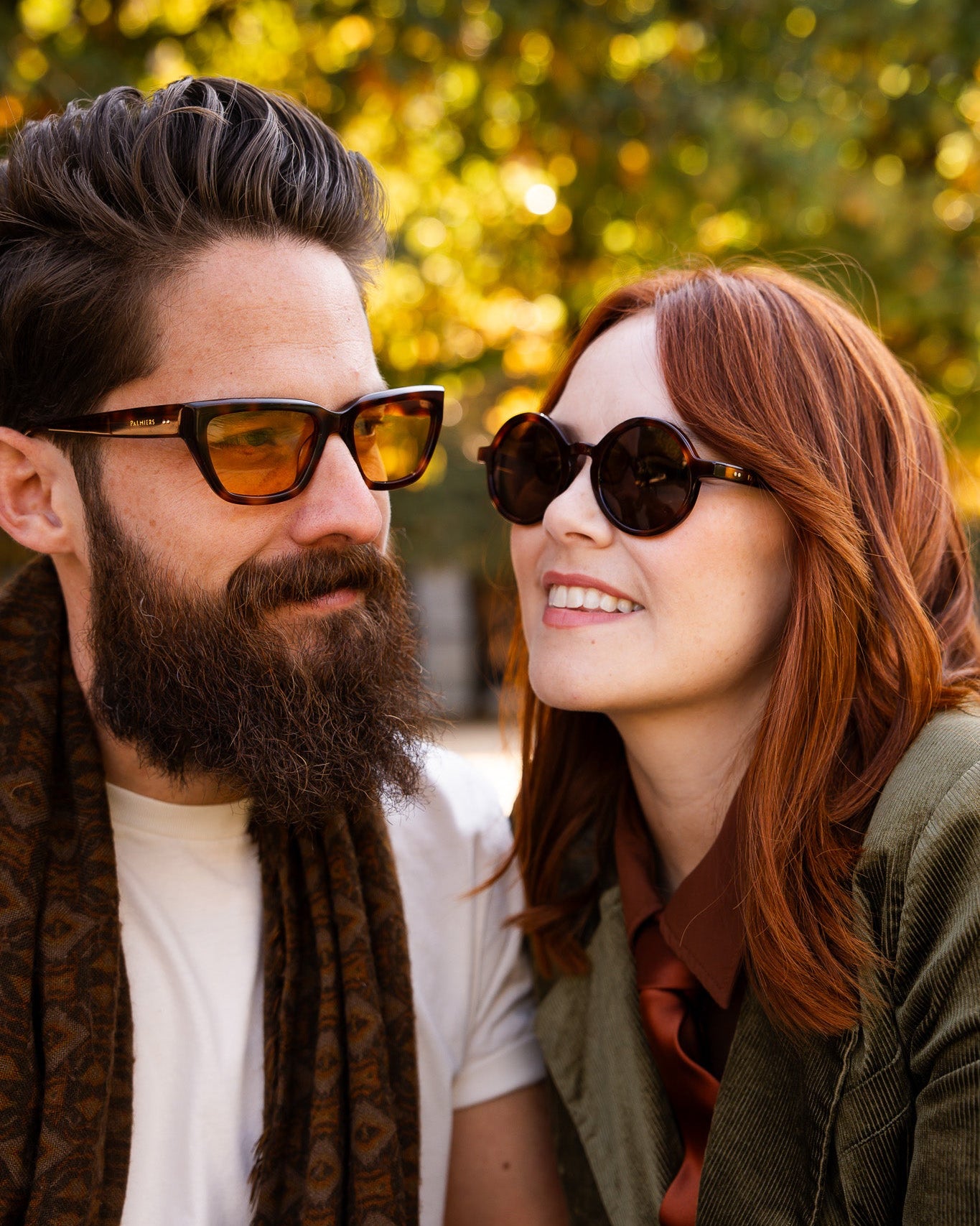 Palmiers Eyewear sunglasses in Saffron and Espresso worn by couple outdoors.