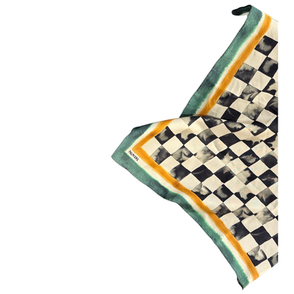 Checkered silk scarf with green border on a white background
